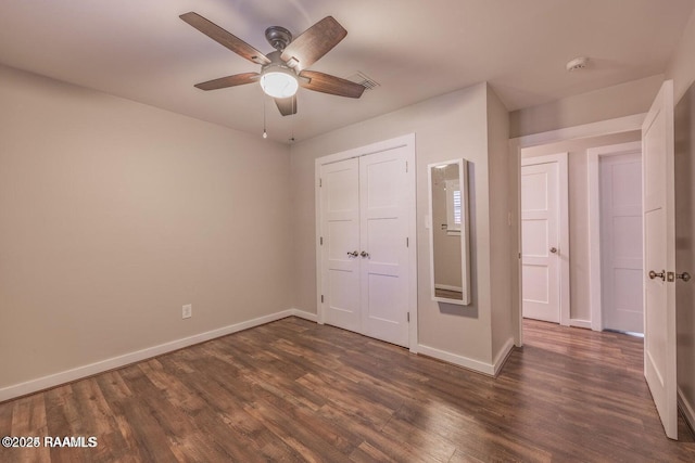 115 Hiawatha Rd, Lafayette, LA 70501 - unfurnished bedroom featuring dark wood-style flooring, baseboards, a closet, and ceiling fan