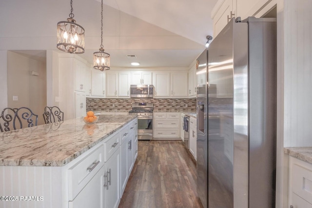 115 Hiawatha Rd, Lafayette, LA 70501 - kitchen with stainless steel appliances, white cabinets, backsplash, dark wood finished floors, and light stone countertops