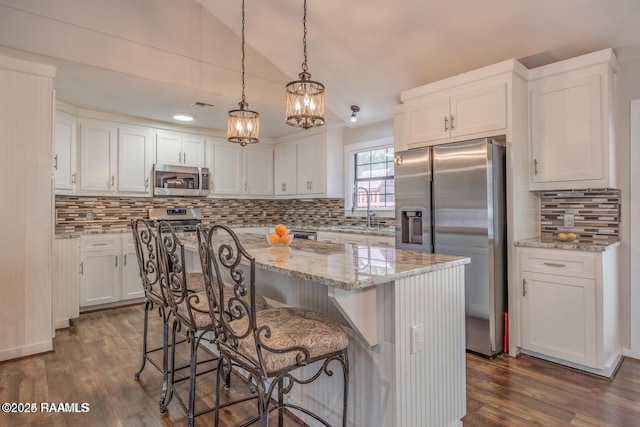 115 Hiawatha Rd, Lafayette, LA 70501 - kitchen featuring stainless steel appliances, a sink, white cabinets, tasteful backsplash, and dark wood-style flooring