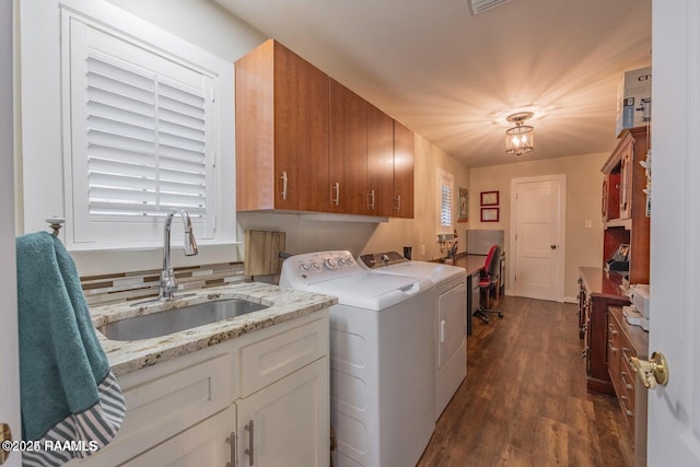 115 Hiawatha Rd, Lafayette, LA 70501 - washroom featuring washing machine and dryer, cabinet space, and dark wood-type flooring