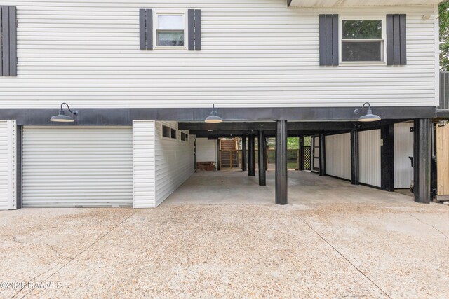 4802 Lafitte St, New Iberia, LA 70560 - garage with driveway and a carport