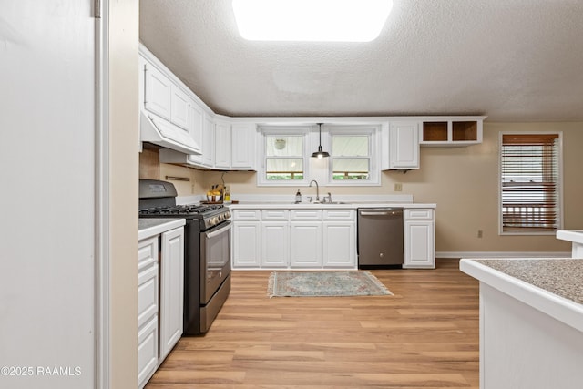4802 Lafitte St, New Iberia, LA 70560 - kitchen featuring stainless steel appliances, under cabinet range hood, a sink, light wood-type flooring, and light countertops