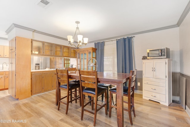 102 Lucas Cir, Lafayette, LA 70508 - dining area featuring a chandelier, crown molding, and light wood-style flooring
