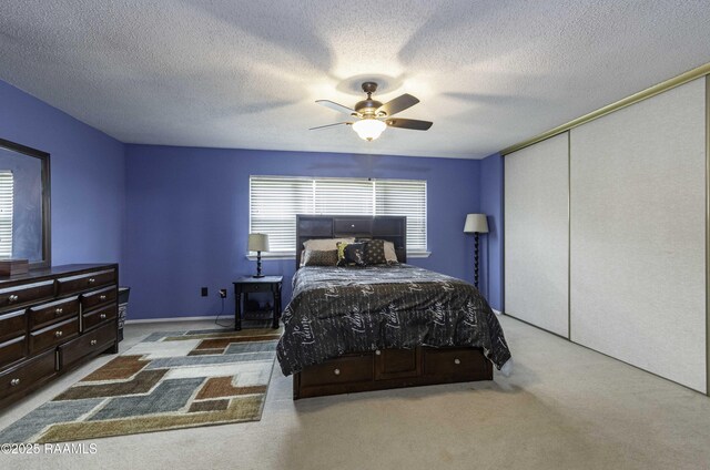 16 Heather Row, Lafayette, LA 70507 - carpeted bedroom featuring a closet, ceiling fan, and a textured ceiling
