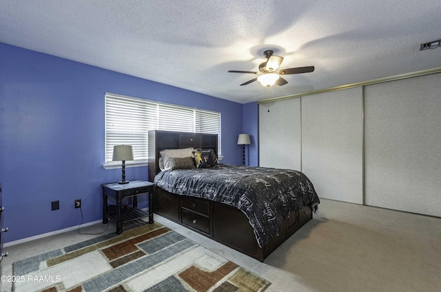 16 Heather Row, Lafayette, LA 70507 - bedroom featuring carpet flooring, a ceiling fan, a closet, and a textured ceiling