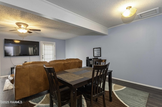 16 Heather Row, Lafayette, LA 70507 - dining area featuring a textured ceiling, dark wood finished floors, ceiling fan, and baseboards