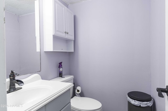 16 Heather Row, Lafayette, LA 70507 - bathroom with a textured ceiling, toilet, and vanity