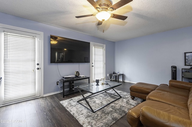 16 Heather Row, Lafayette, LA 70507 - living area featuring dark wood-style flooring, a ceiling fan, baseboards, and a textured ceiling