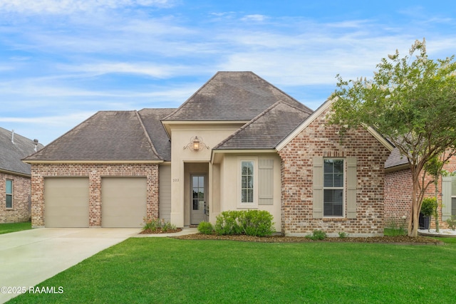 203 Sanctuary Ln, Lafayette, LA 70503 - french provincial home with a garage, concrete driveway, brick siding, a front yard, and roof with shingles