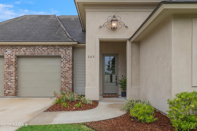 203 Sanctuary Ln, Lafayette, LA 70503 - entrance to property with a garage, brick siding, concrete driveway, and a shingled roof