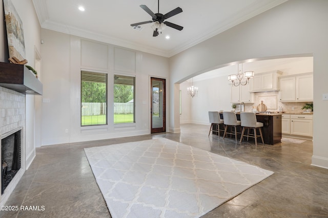 203 Sanctuary Ln, Lafayette, LA 70503 - living area with a chandelier, a fireplace, ornamental molding, ceiling fan, and recessed lighting