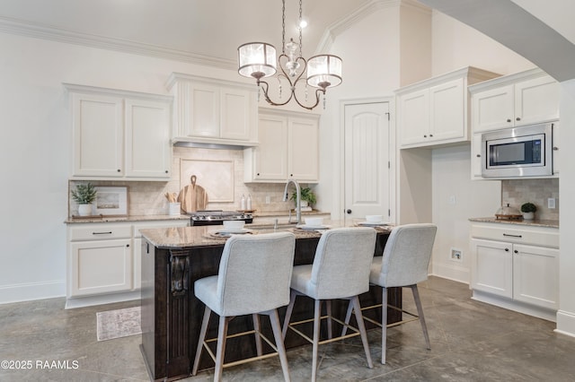 203 Sanctuary Ln, Lafayette, LA 70503 - kitchen with stainless steel appliances, backsplash, white cabinets, and crown molding