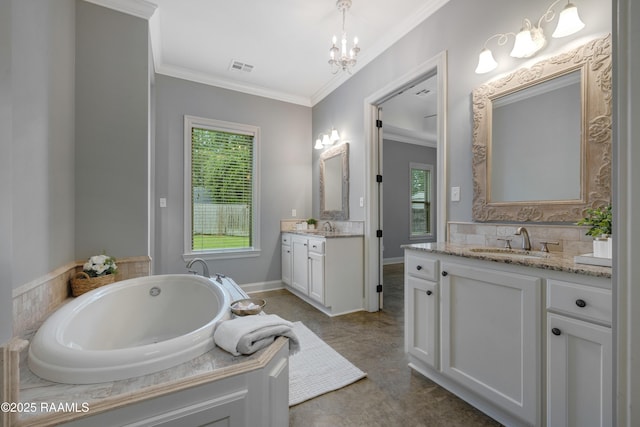 203 Sanctuary Ln, Lafayette, LA 70503 - bathroom with two vanities, a chandelier, healthy amount of natural light, ornamental molding, and a bath