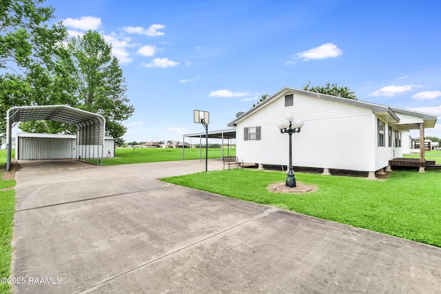 231 La Compagne St, Opelousas, LA 70570 - view of side of property with a yard, concrete driveway, and a carport