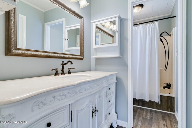 231 La Compagne St, Opelousas, LA 70570 - full bathroom featuring crown molding, wood finished floors, vanity, and shower / bath combo with shower curtain