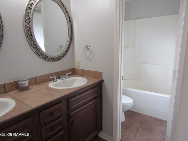 1503 S Patout St, New Iberia, LA 70560 - bathroom with toilet, double vanity, and tile patterned flooring