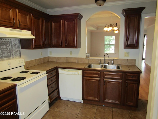 1503 S Patout St, New Iberia, LA 70560 - kitchen featuring white appliances, under cabinet range hood, a sink, arched walkways, and ornamental molding