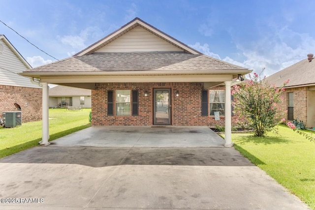 1503 S Patout St, New Iberia, LA 70560 - view of front of house featuring a shingled roof, a front lawn, brick siding, and driveway