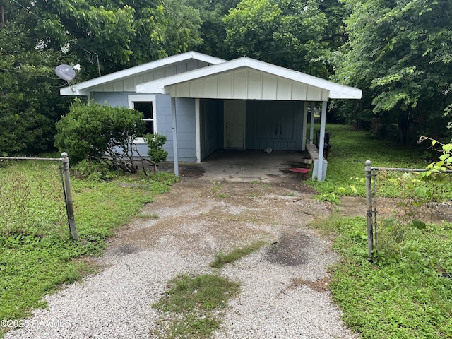 2341/2 N Pine St, Lafayette, LA 70501 - view of front of home featuring driveway, board and batten siding, and a detached carport