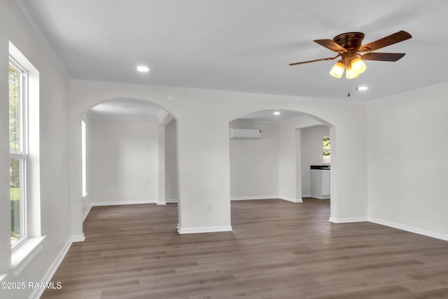 630 Ledoux St, Jennings, LA 70546 - unfurnished room with arched walkways, ceiling fan, wood finished floors, recessed lighting, and baseboards