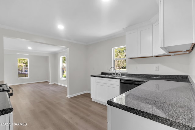 630 Ledoux St, Jennings, LA 70546 - kitchen with dishwashing machine, a sink, ornamental molding, white cabinets, and light wood finished floors