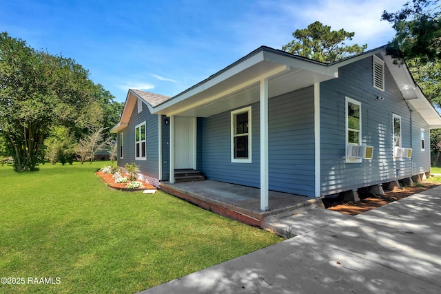 630 Ledoux St, Jennings, LA 70546 - view of side of property with a lawn, cooling unit, and a porch