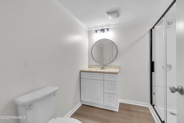 630 Ledoux St, Jennings, LA 70546 - full bath featuring crown molding, vanity, toilet, a stall shower, and wood finished floors