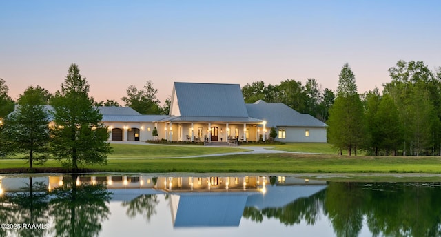 235 N Fieldspan Rd, Scott, LA 70583 - back of house with a water view, a lawn, and metal roof