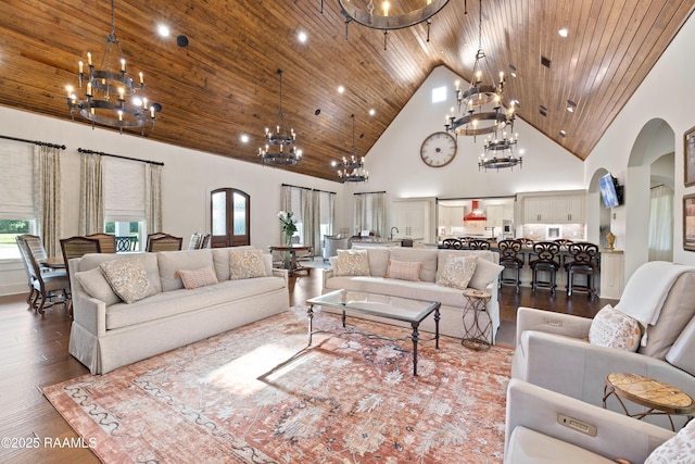 235 N Fieldspan Rd, Scott, LA 70583 - living room with a chandelier, arched walkways, wood finished floors, high vaulted ceiling, and wood ceiling