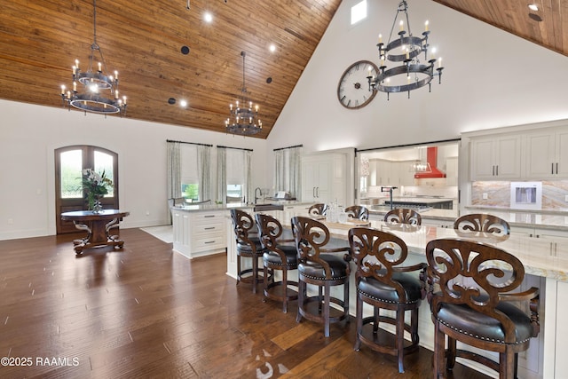235 N Fieldspan Rd, Scott, LA 70583 - dining area with a chandelier, high vaulted ceiling, wood ceiling, dark wood-type flooring, and arched walkways