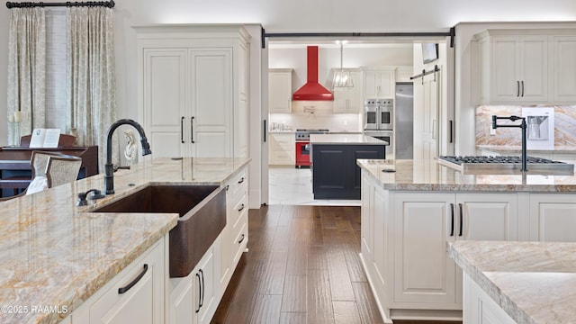 235 N Fieldspan Rd, Scott, LA 70583 - kitchen featuring a sink, wall chimney exhaust hood, appliances with stainless steel finishes, and decorative backsplash