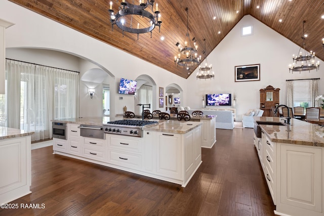235 N Fieldspan Rd, Scott, LA 70583 - kitchen featuring a chandelier, a large island with sink, stainless steel gas stovetop, a warming drawer, and a sink