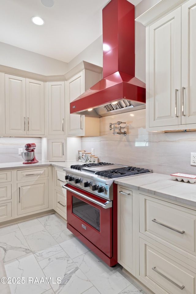 235 N Fieldspan Rd, Scott, LA 70583 - kitchen with high end stainless steel range oven, island range hood, light marble finish flooring, recessed lighting, and backsplash