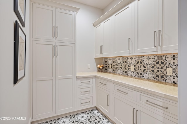 235 N Fieldspan Rd, Scott, LA 70583 - kitchen with decorative backsplash, white cabinets, light tile patterned floors, and light stone countertops