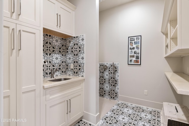 235 N Fieldspan Rd, Scott, LA 70583 - laundry area with a sink, baseboards, and light tile patterned flooring