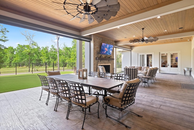 235 N Fieldspan Rd, Scott, LA 70583 - view of patio / terrace featuring a stone fireplace, ceiling fan, outdoor dining space, and french doors