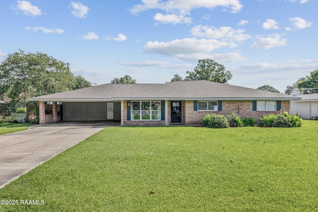 421 Karen Dr, Lafayette, LA 70503 - ranch-style home with an attached carport, concrete driveway, a front lawn, brick siding, and a shingled roof