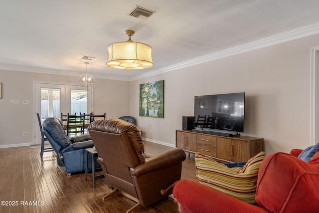 421 Karen Dr, Lafayette, LA 70503 - living room featuring dark wood-style flooring, crown molding, baseboards, and a chandelier