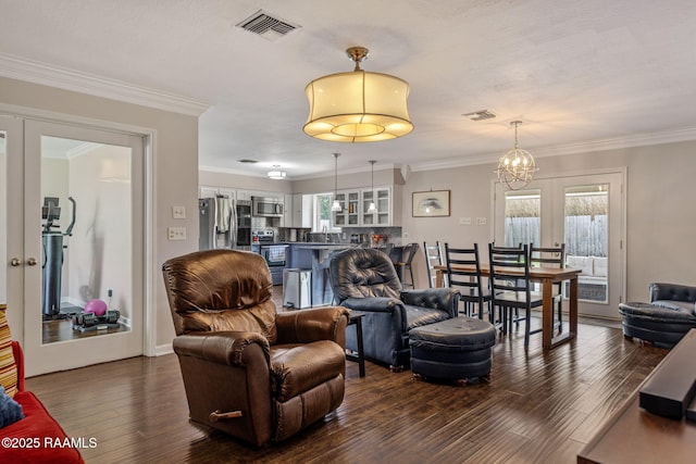 421 Karen Dr, Lafayette, LA 70503 - living area featuring dark wood-style floors, crown molding, and a chandelier