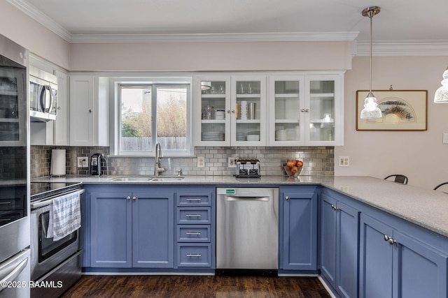 421 Karen Dr, Lafayette, LA 70503 - kitchen with appliances with stainless steel finishes, a sink, blue cabinetry, ornamental molding, and glass insert cabinets