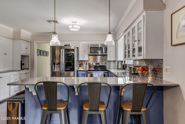 421 Karen Dr, Lafayette, LA 70503 - kitchen with appliances with stainless steel finishes, decorative backsplash, white cabinets, ornamental molding, and a sink