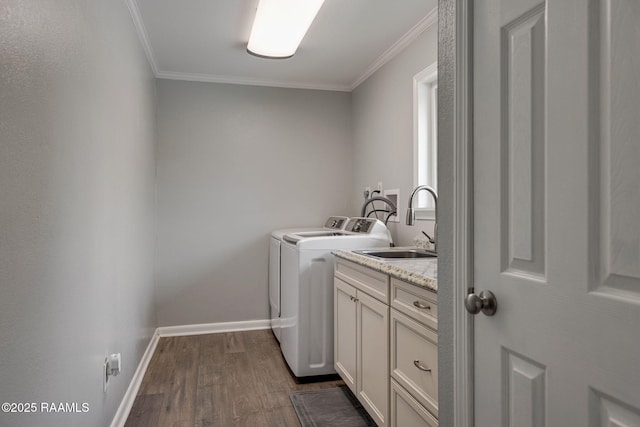 421 Karen Dr, Lafayette, LA 70503 - laundry room featuring washing machine and dryer, dark wood-type flooring, cabinet space, ornamental molding, and baseboards