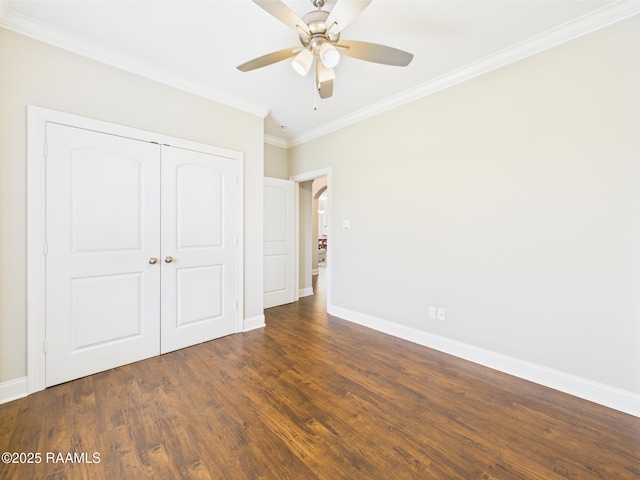120 Old Heritage Ln, Carencro, LA 70520 - unfurnished bedroom featuring ornamental molding, a closet, baseboards, wood finished floors, and arched walkways