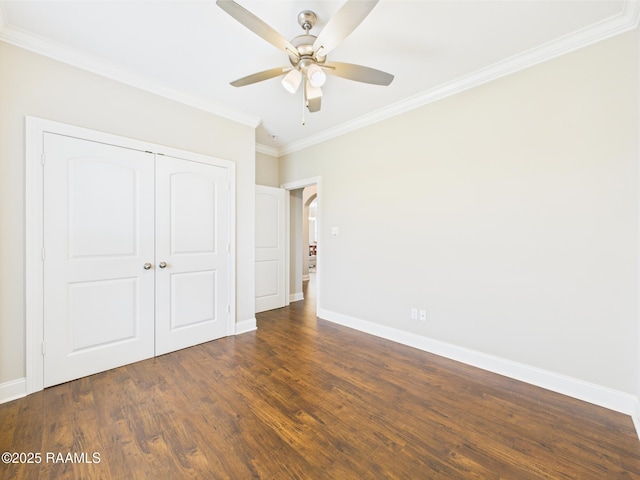 120 Old Heritage Ln, Carencro, LA 70520 - unfurnished bedroom with ornamental molding, baseboards, a closet, dark wood-style floors, and arched walkways