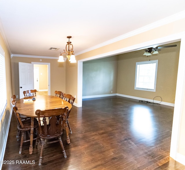 306 Oak St, Iota, LA 70543 - dining area with ornamental molding, dark wood-style floors, a chandelier, and baseboards