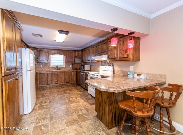 306 Oak St, Iota, LA 70543 - kitchen with a peninsula, appliances with stainless steel finishes, under cabinet range hood, crown molding, and backsplash