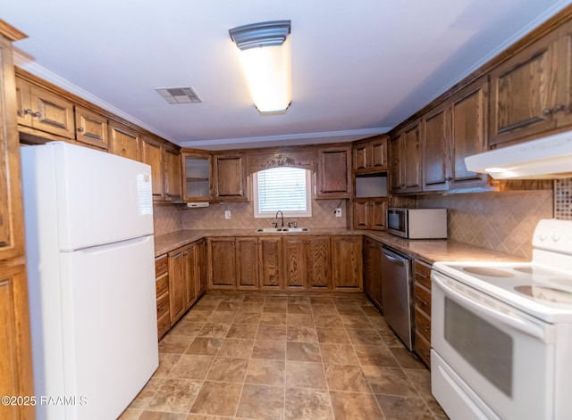 306 Oak St, Iota, LA 70543 - kitchen with appliances with stainless steel finishes, under cabinet range hood, backsplash, and a sink