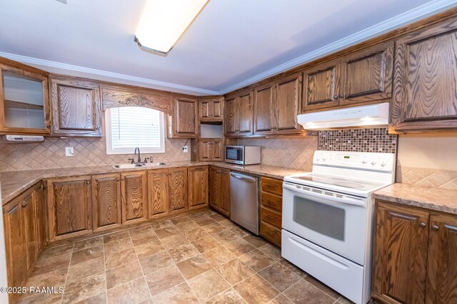 306 Oak St, Iota, LA 70543 - kitchen featuring under cabinet range hood, stainless steel appliances, a sink, and tasteful backsplash