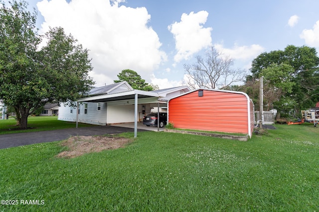 306 Oak St, Iota, LA 70543 - view of green lawn with asphalt driveway and an attached carport
