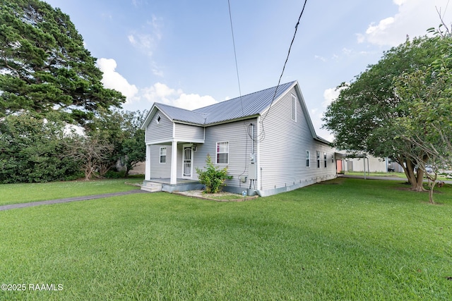 306 Oak St, Iota, LA 70543 - view of front of home with a front yard and metal roof